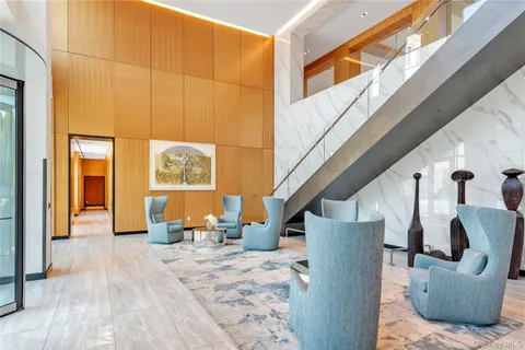 a living room with furniture and a floor to ceiling window