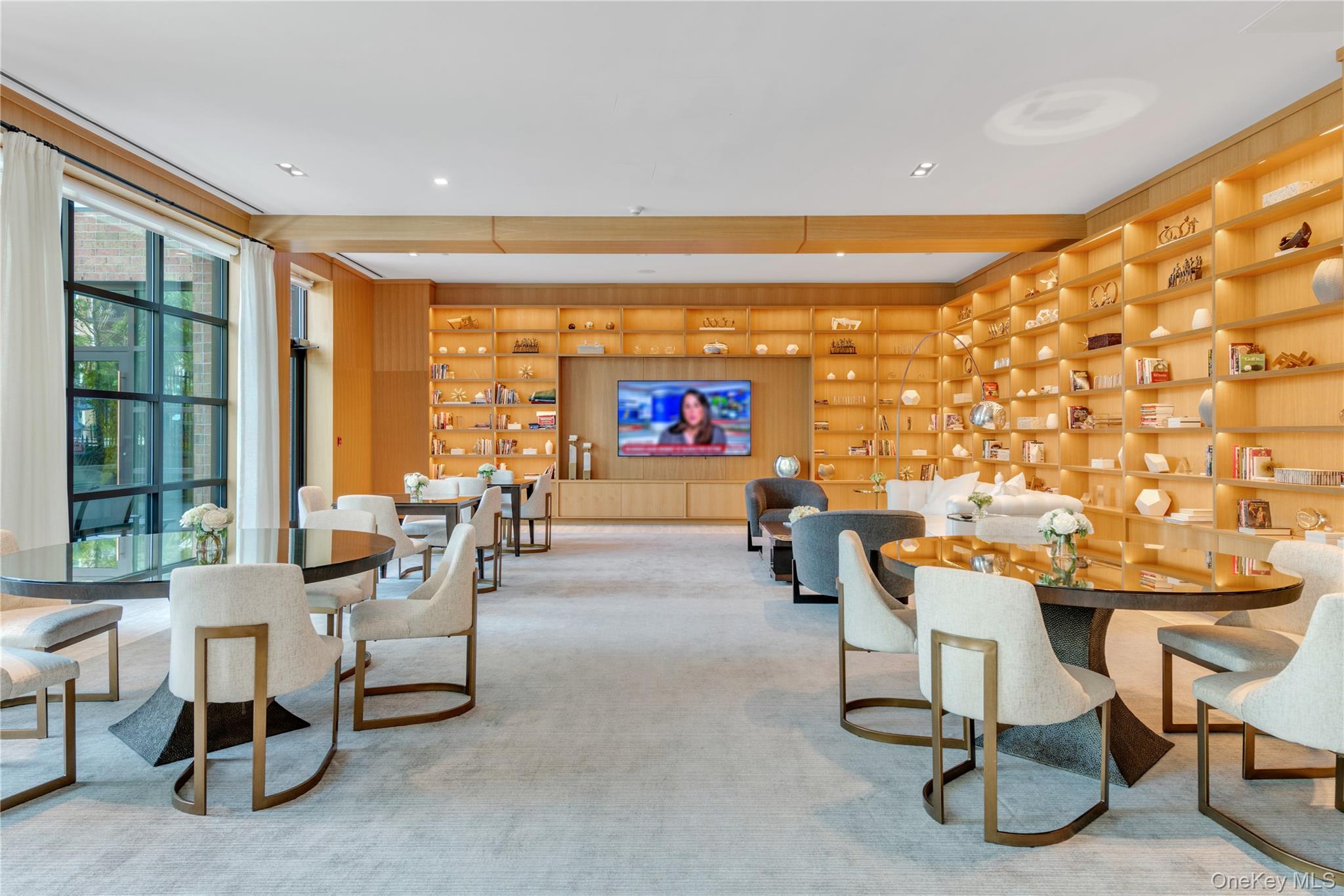 100 Garvies Point Road, Unit 1238 Glen Cove, NY 11542 - Photo 26 of 41 a living room with furniture a floor to ceiling window and a flat screen tv