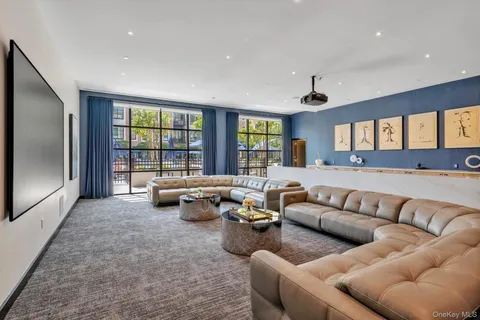 a living room with fireplace furniture and a large window