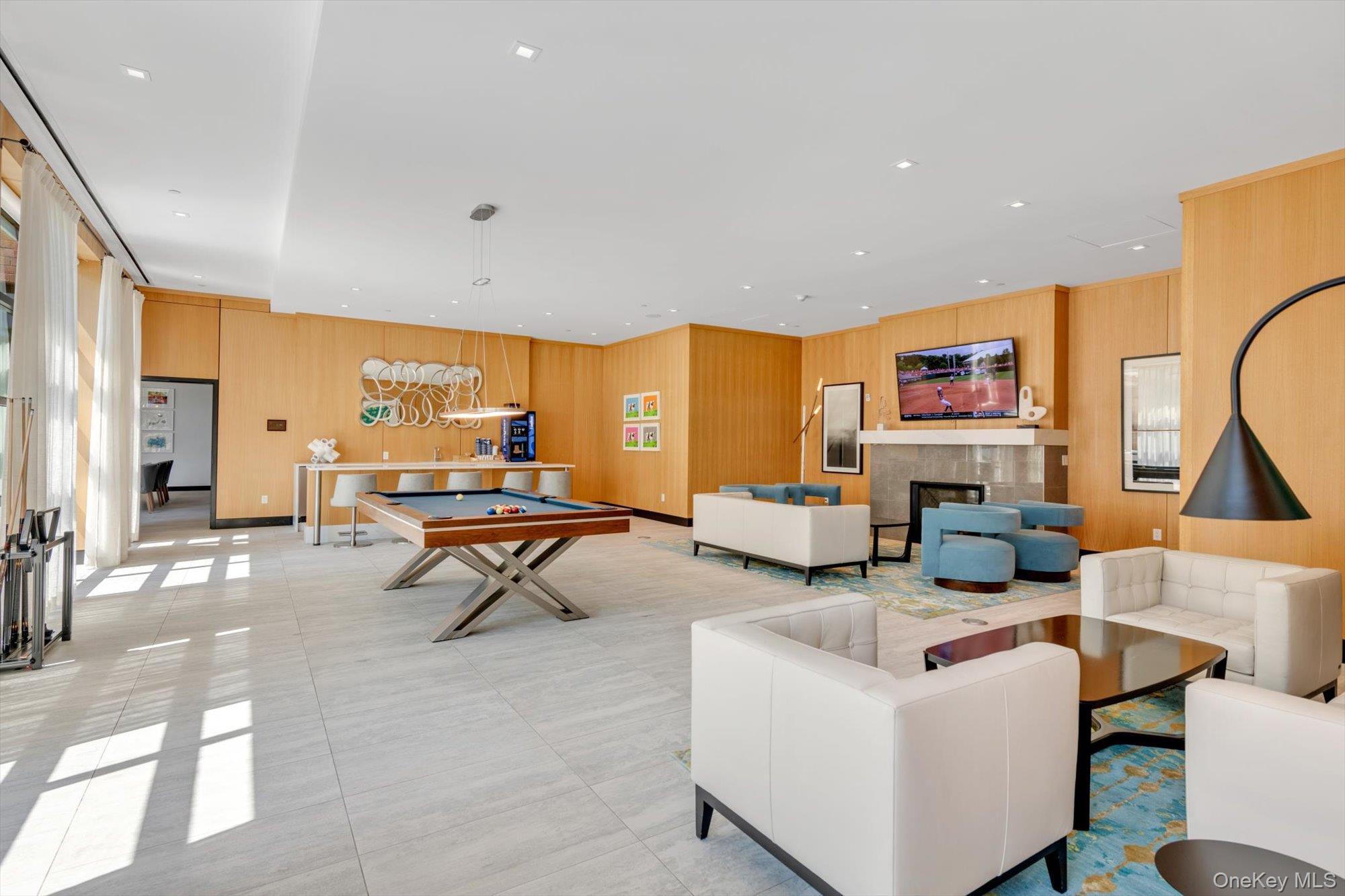 100 Garvies Point Road, Unit 1238 Glen Cove, NY 11542 - Photo 30 of 41 a living room with fireplace furniture and a large window