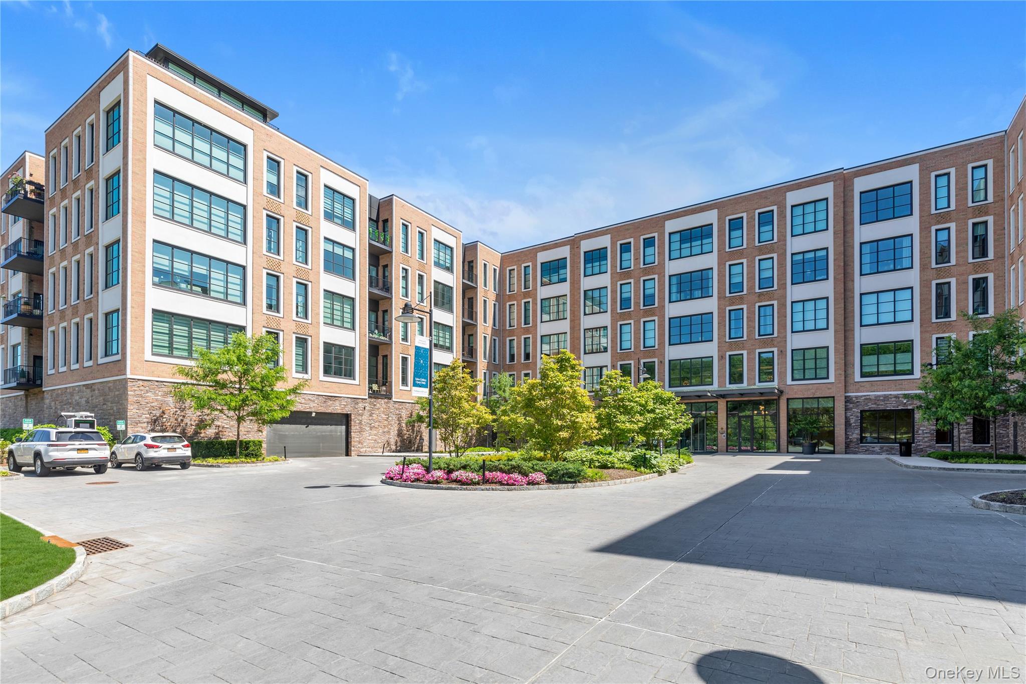 100 Garvies Point Road, Unit 1238 Glen Cove, NY 11542 - Photo 33 of 41 a front view of a building with garden