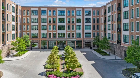 a front view of a building with a garden