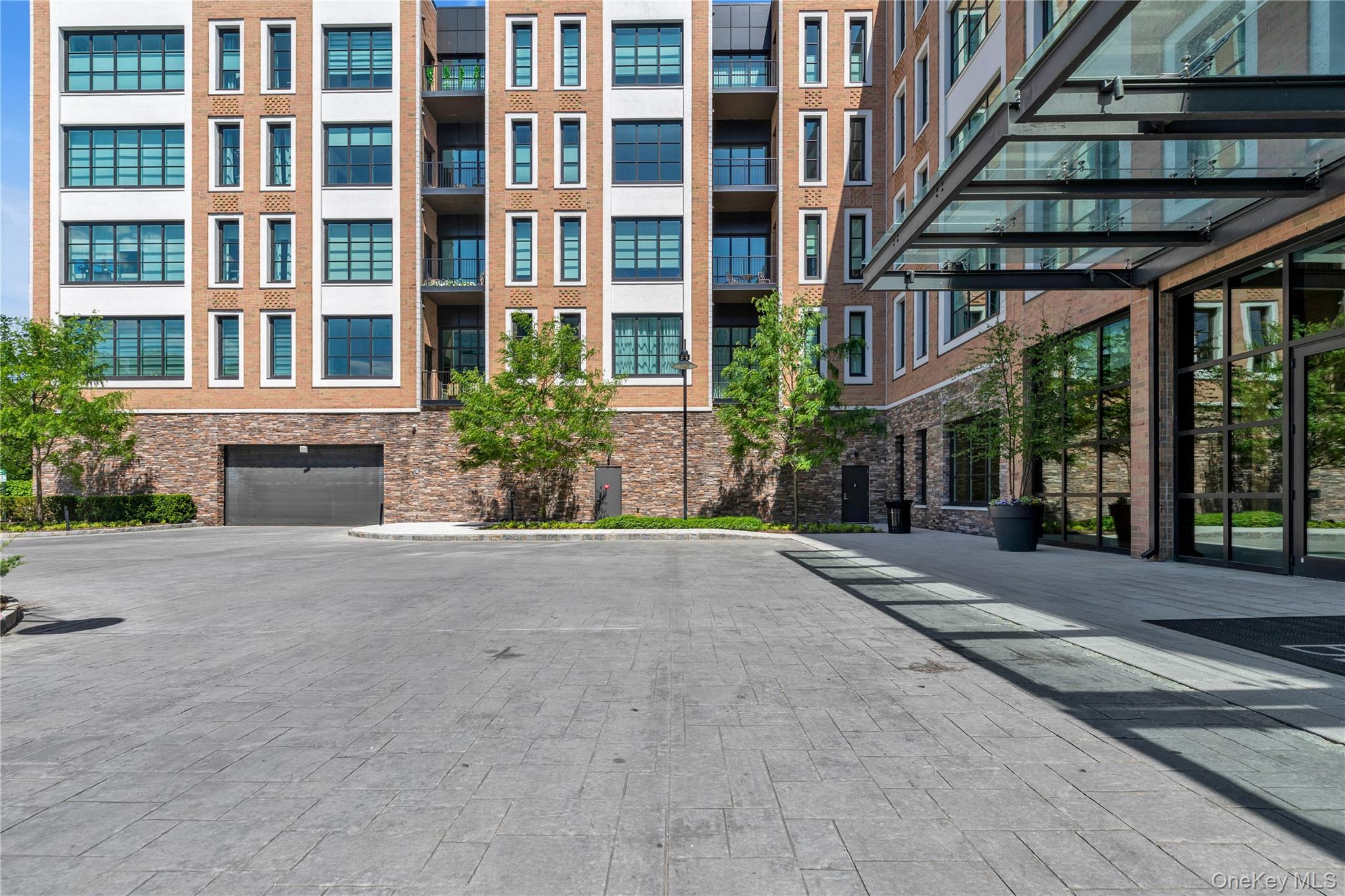 100 Garvies Point Road, Unit 1238 Glen Cove, NY 11542 - Photo 39 of 41 a front view of a building with a garden