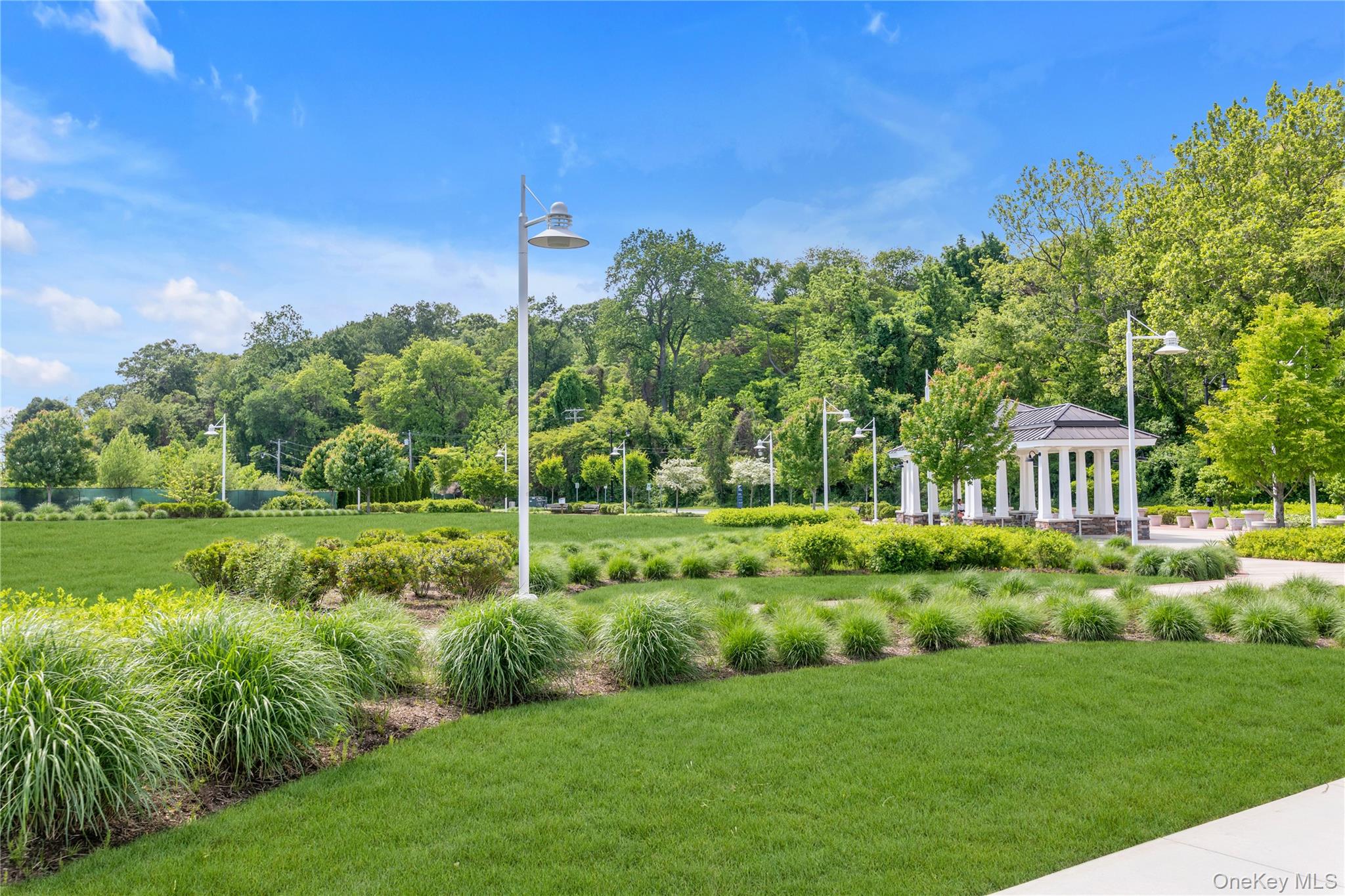 100 Garvies Point Road, Unit 1238 Glen Cove, NY 11542 - Photo 41 of 41 a view of a garden with a house in the background