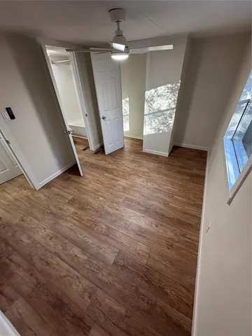 a view of an entryway with wooden floor