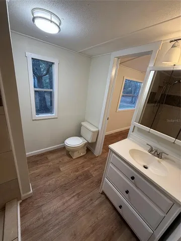a bathroom with a toilet sink and a mirror