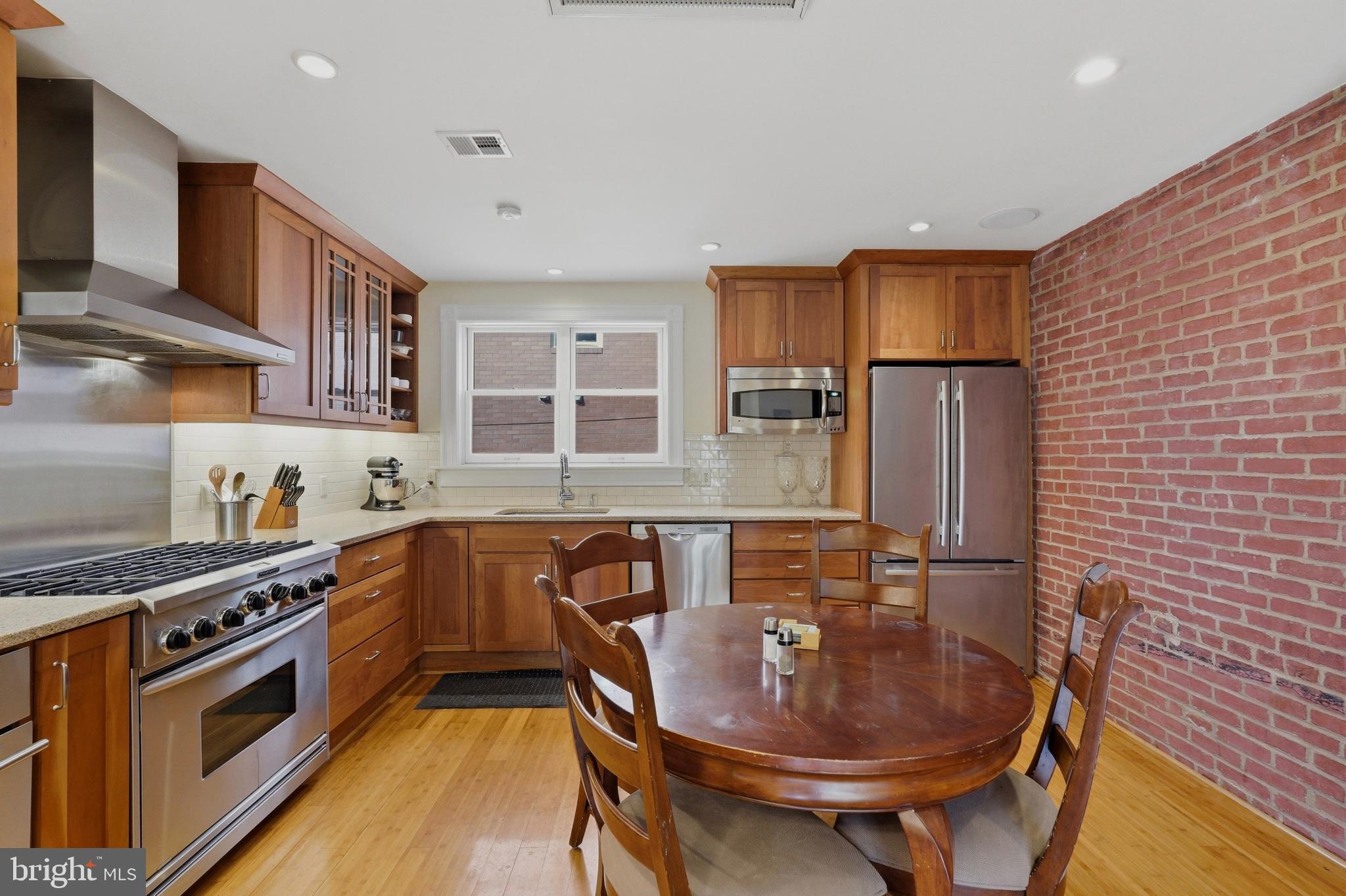 1002 N Street Northwest Washington, DC 20001 - Photo 12 of 33 a kitchen with stainless steel appliances granite countertop a stove a sink dishwasher and cabinets
