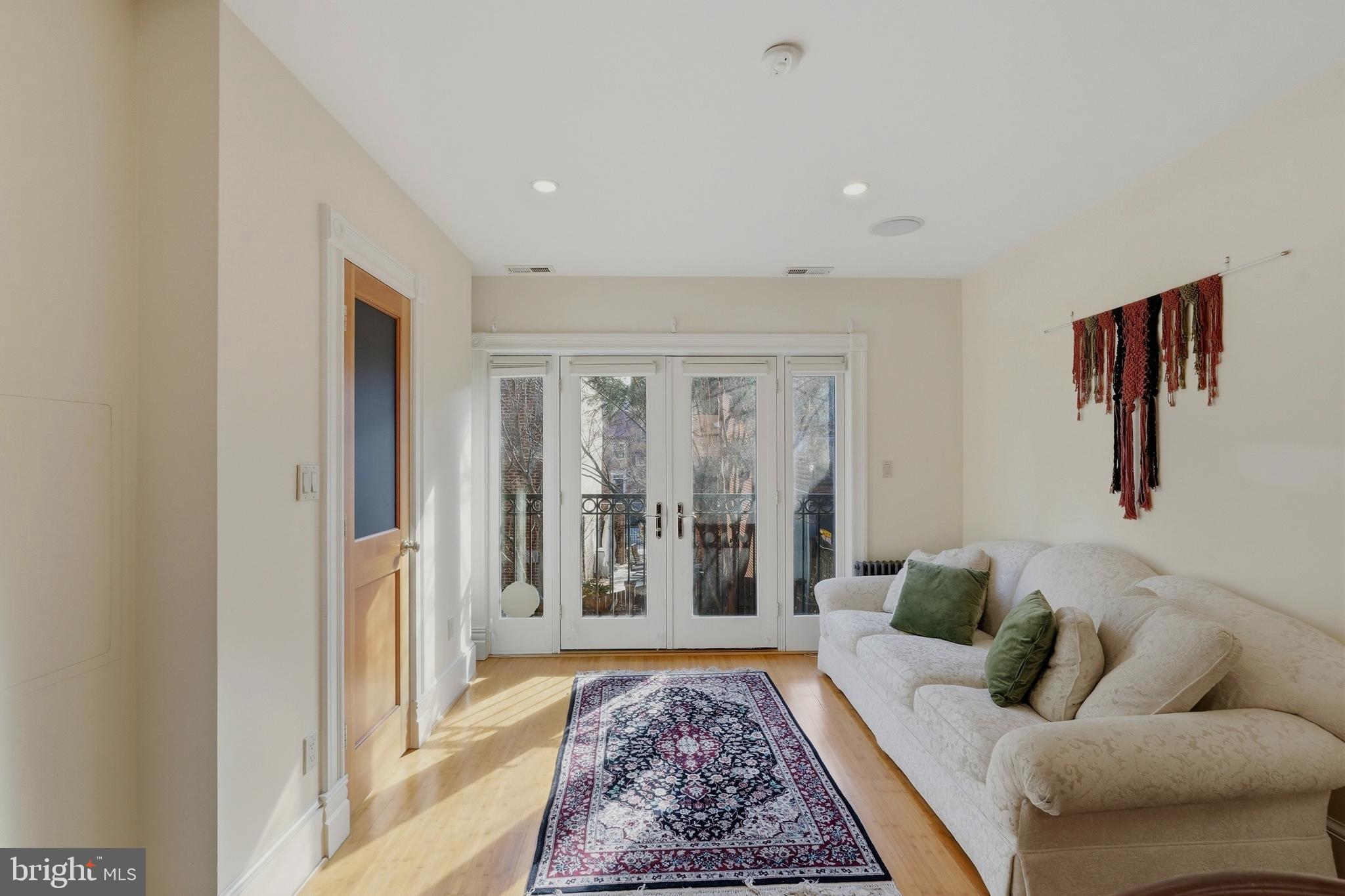 1002 N Street Northwest Washington, DC 20001 - Photo 13 of 33 a living room with furniture and a rug