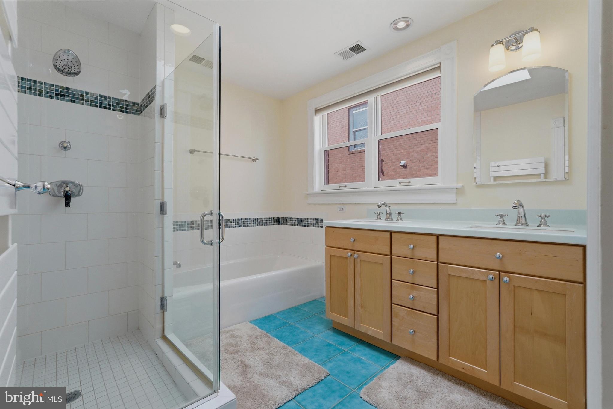 1002 N Street Northwest Washington, DC 20001 - Photo 22 of 33 a spacious bathroom with a granite countertop sink mirror and shower