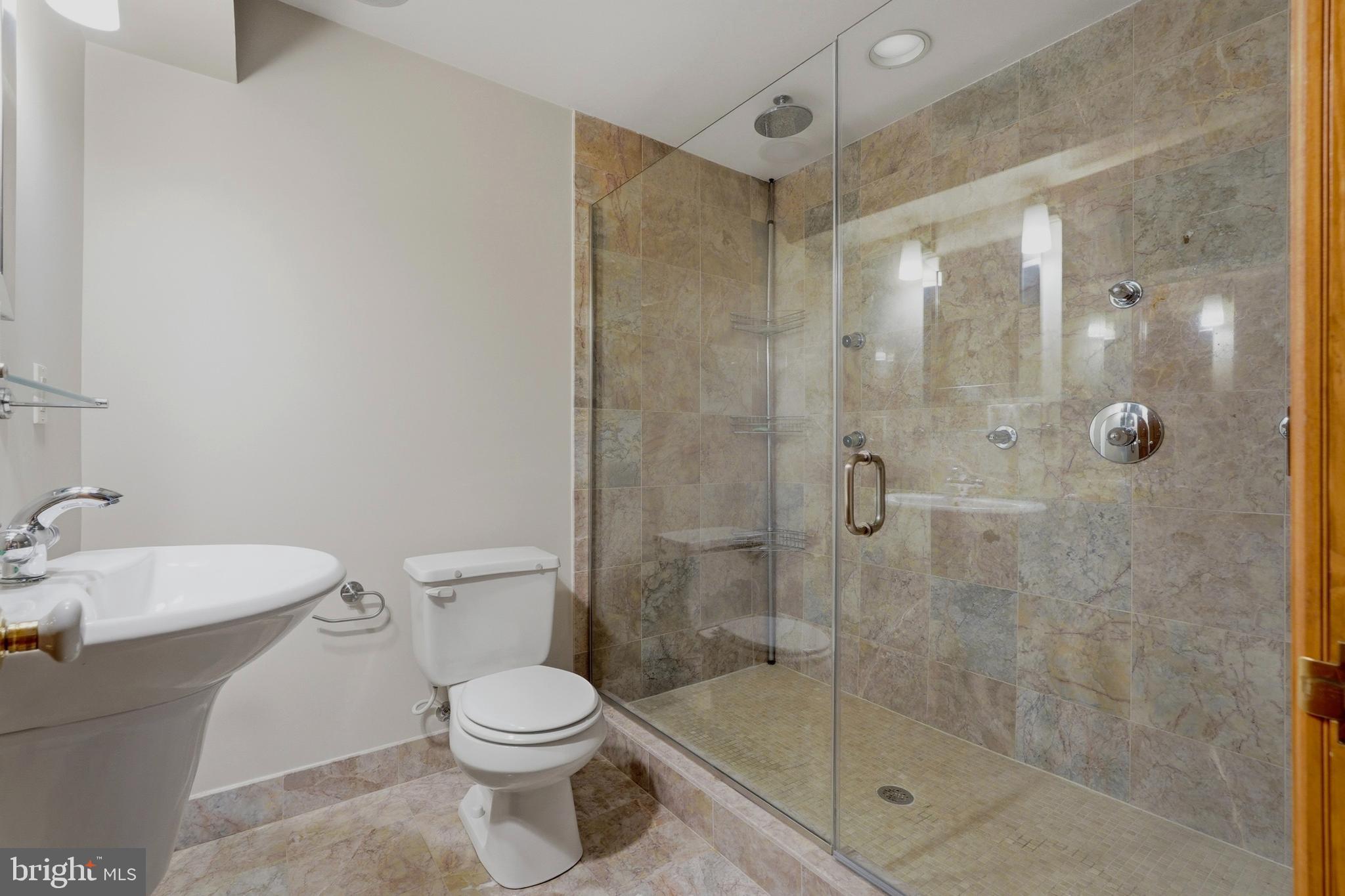 1002 N Street Northwest Washington, DC 20001 - Photo 27 of 33 a bathroom with a shower a toilet and a sink