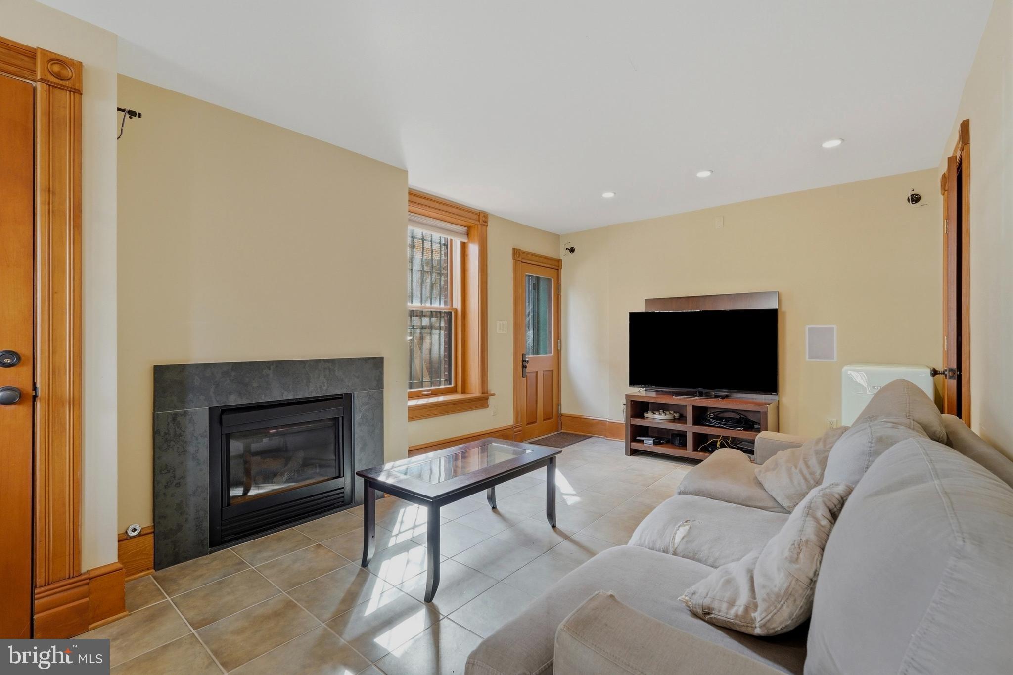 1002 N Street Northwest Washington, DC 20001 - Photo 28 of 33 a living room with furniture and a flat screen tv