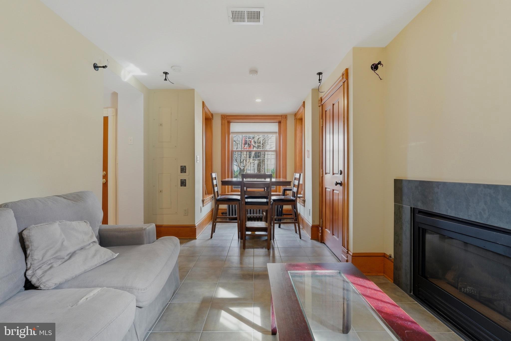 1002 N Street Northwest Washington, DC 20001 - Photo 29 of 33 a living room with furniture and a fireplace