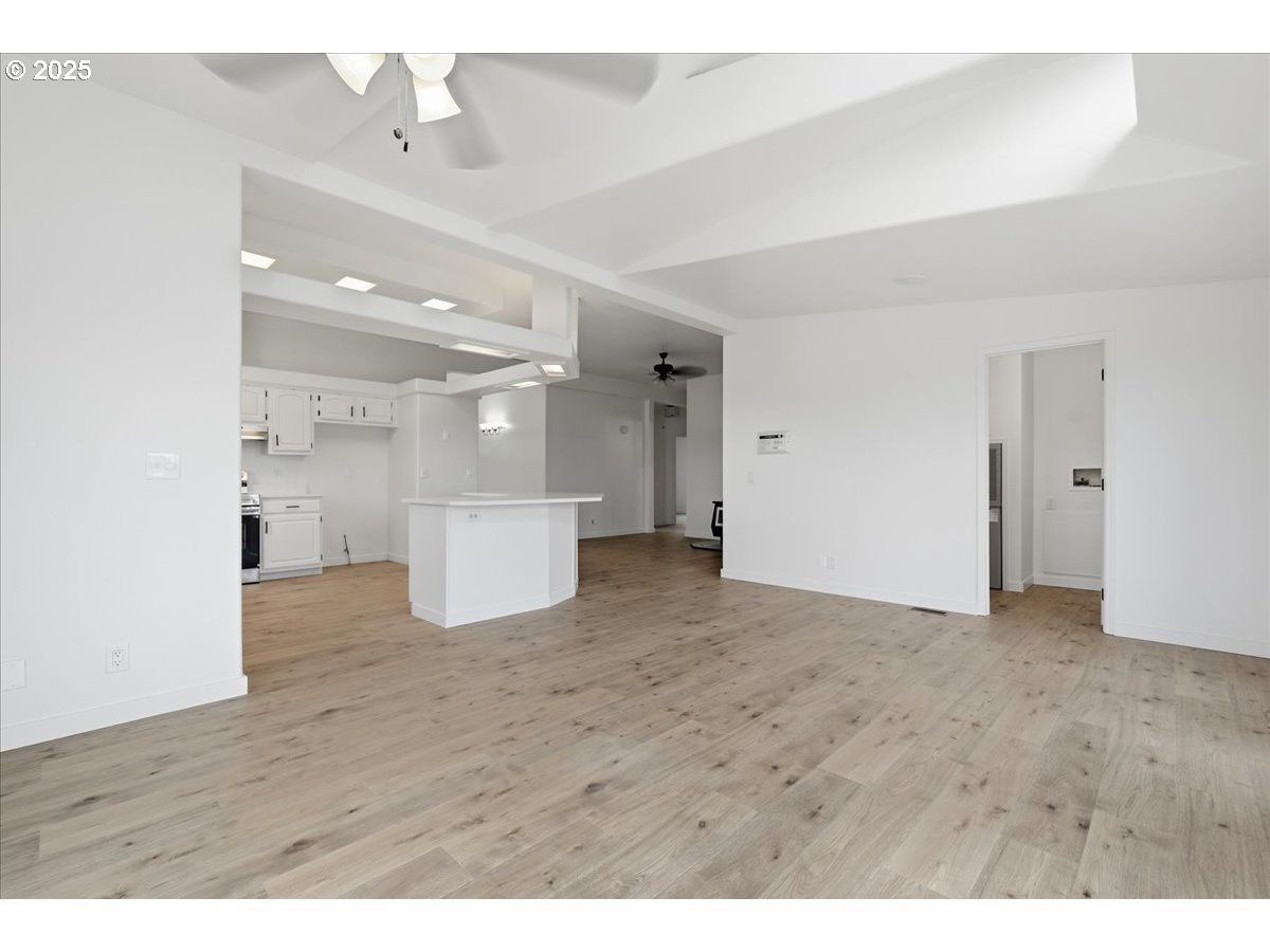 499 Alderdale Road Prosser, WA 99350 - Photo 12 of 41 a view of a big room with wooden floor and windows