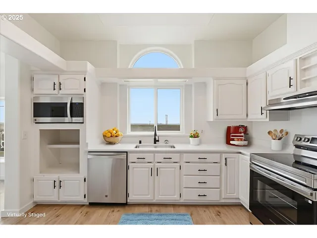 a kitchen with stainless steel appliances a sink stove and cabinets