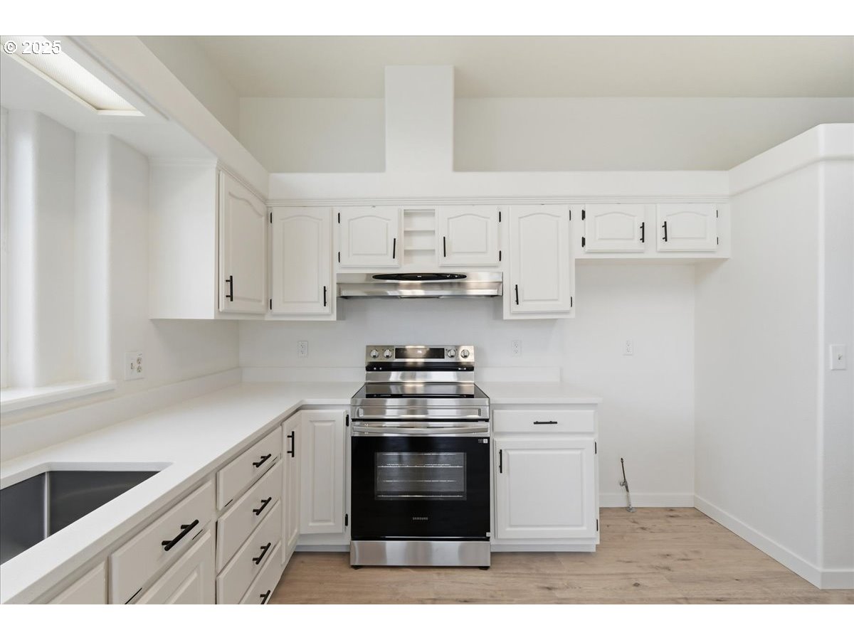 499 Alderdale Road Prosser, WA 99350 - Photo 17 of 41 a kitchen with cabinets appliances and a sink