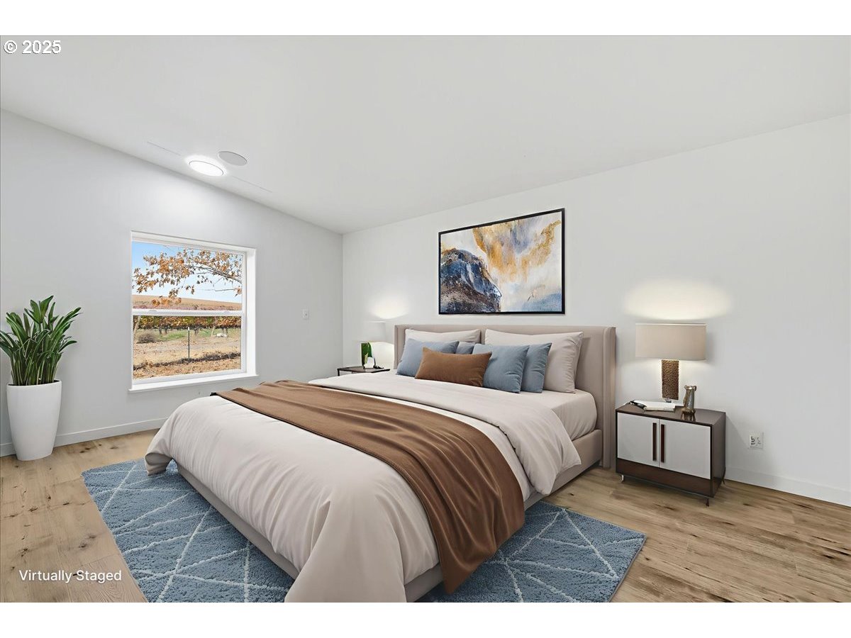 499 Alderdale Road Prosser, WA 99350 - Photo 19 of 41 a bedroom with a large bed a painting and a window