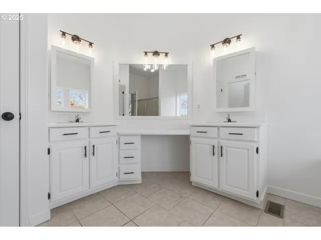 a bathroom with a sink vanity and mirror