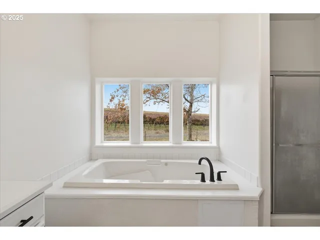 a bathroom with a bathtub and a window
