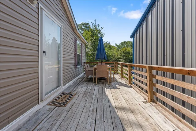 a view of balcony with wooden floor and fence