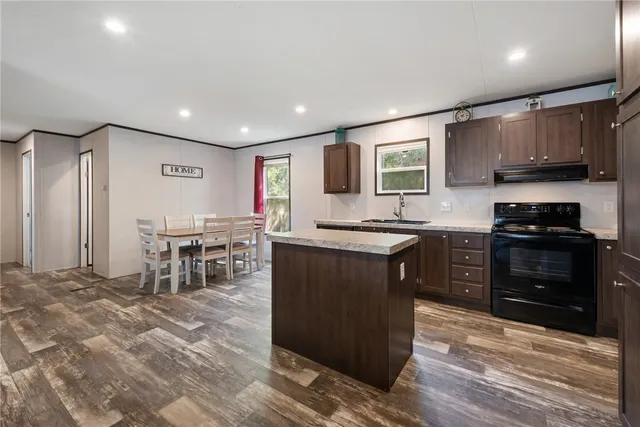a kitchen with stainless steel appliances granite countertop a stove and a refrigerator