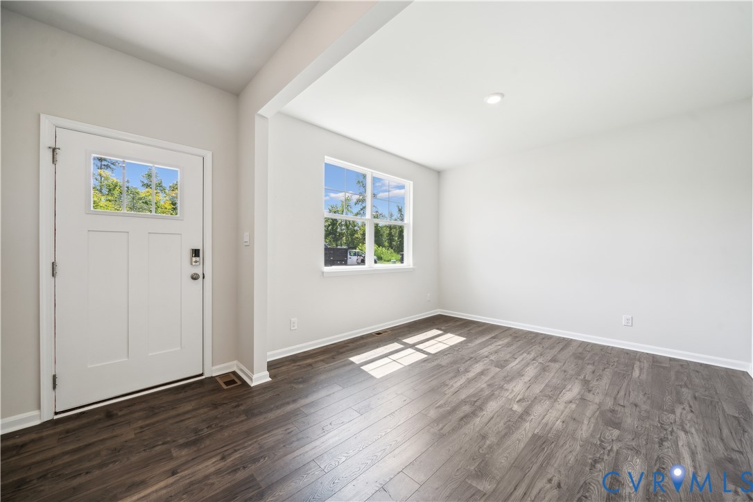 9529 Fuchsia Drive Richmond, VA 23237 - Photo 11 of 28 an empty room with wooden floor and windows