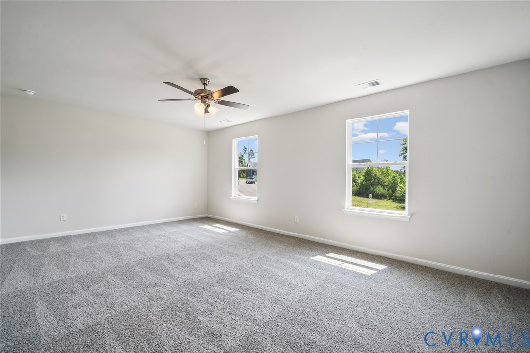 9529 Fuchsia Drive Richmond, VA 23237 - Photo 13 of 28 an empty room with windows and fan