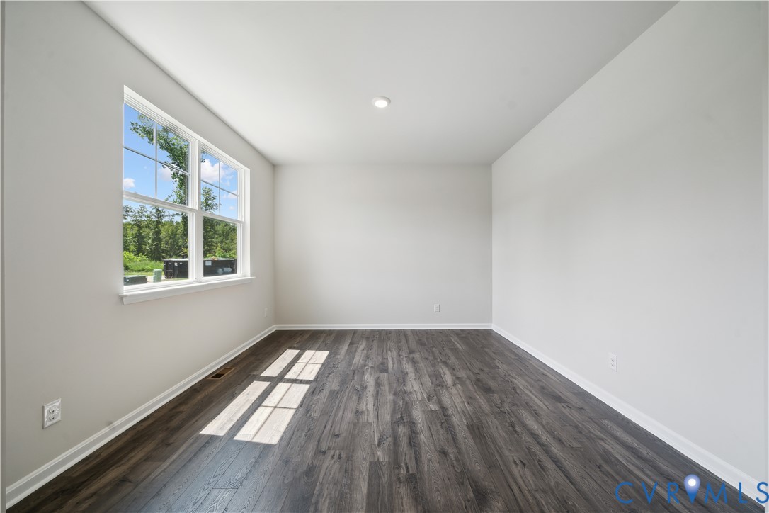 9529 Fuchsia Drive Richmond, VA 23237 - Photo 14 of 28 an empty room with wooden floor and windows