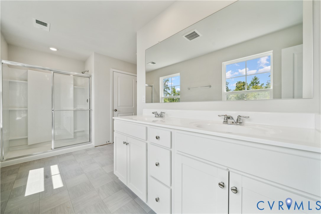 9529 Fuchsia Drive Richmond, VA 23237 - Photo 16 of 28 a spacious bathroom with double sink and a bathtub