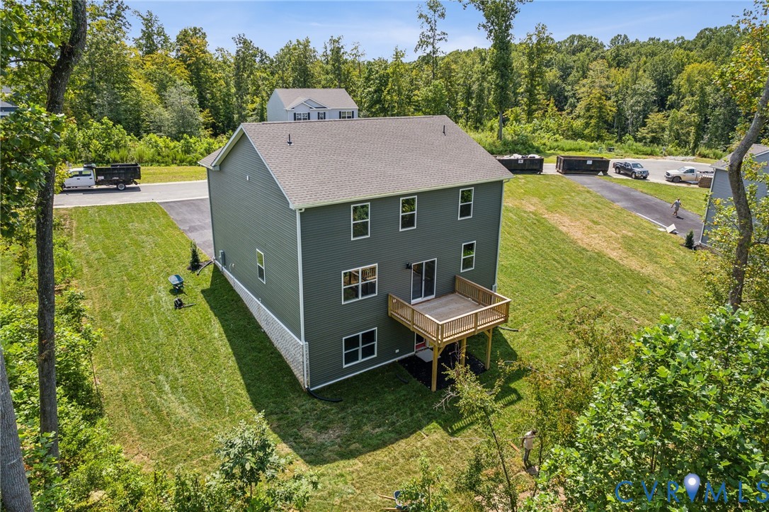 9529 Fuchsia Drive Richmond, VA 23237 - Photo 28 of 28 a view of a swimming pool with a garden and trees