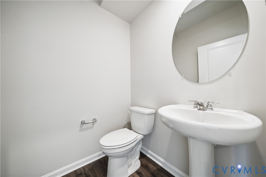 9529 Fuchsia Drive Richmond, VA 23237 - Photo 10 of 28 a bathroom with a sink a mirror and a toilet