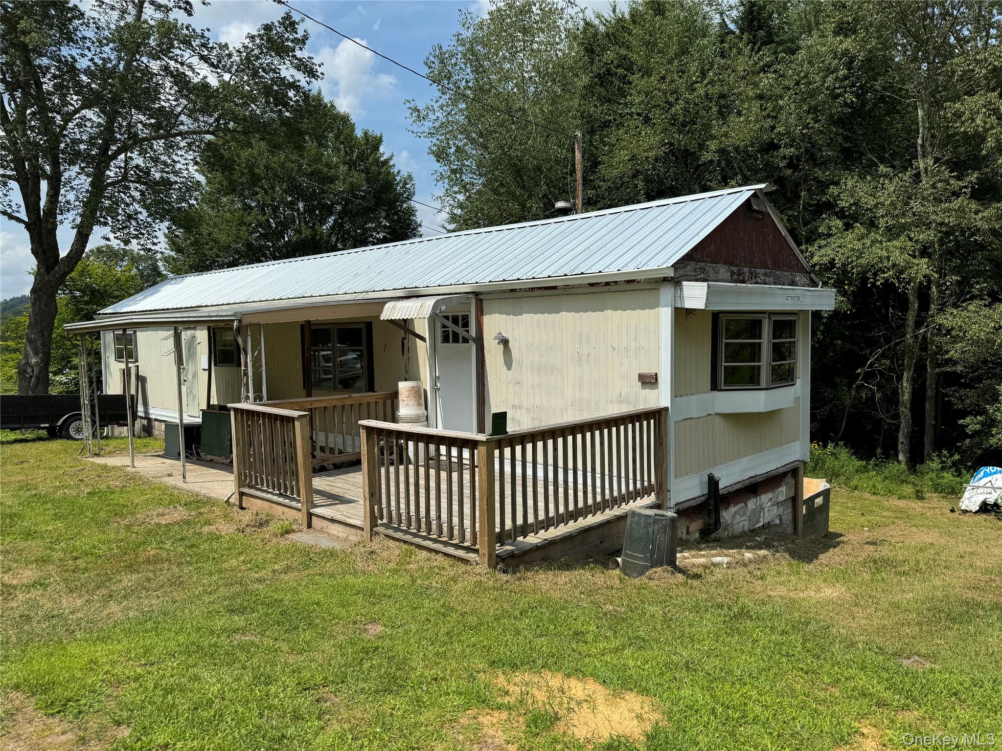 204 Mongaup Road Fallsburg, NY 12747 - Photo 1 of 10 View of front of property with a front yard and a metal roof