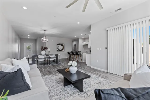 a living room with furniture a rug and a chandelier