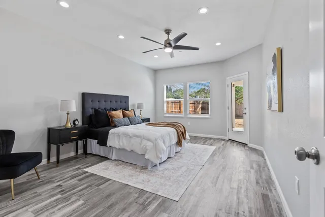 a bedroom with a bed and wooden floor