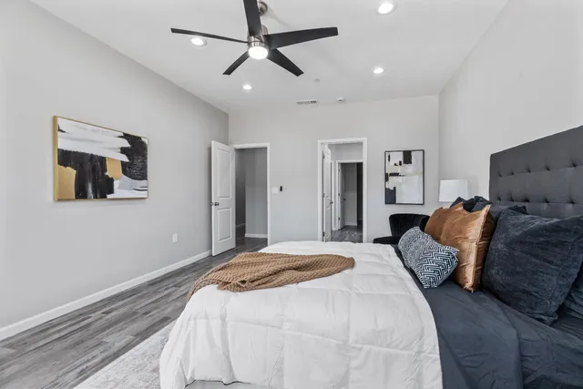a bedroom with a large bed and a chandelier