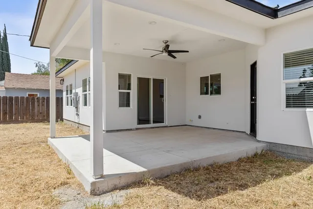 a view of a big room with wooden floor and a ceiling fan
