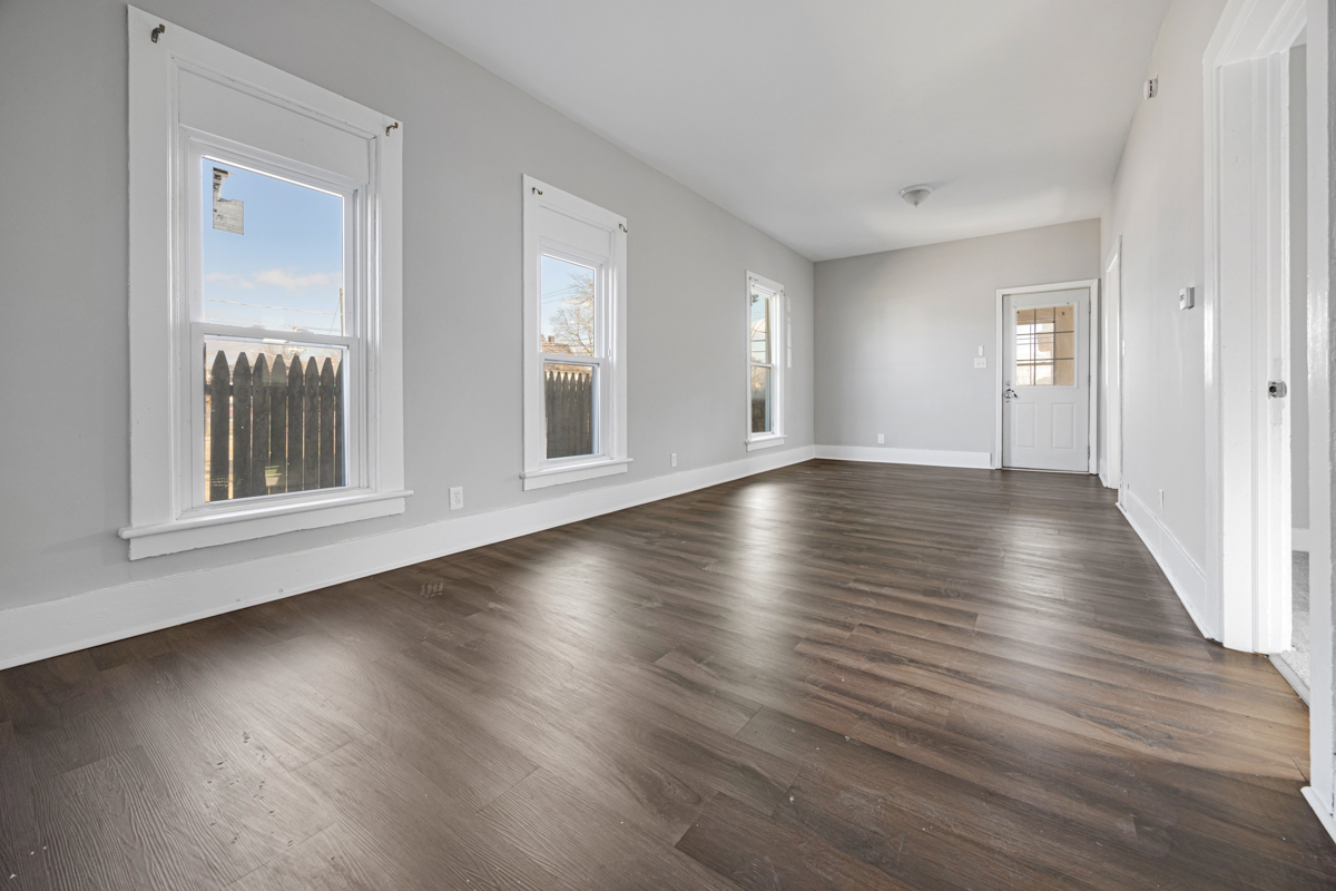 464 Prospect Boulevard Elgin, IL 60120 - Photo 4 of 17 an empty room with wooden floor and windows