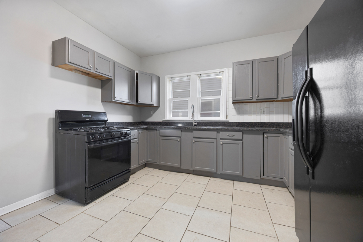 464 Prospect Boulevard Elgin, IL 60120 - Photo 9 of 17 a kitchen with stainless steel appliances granite countertop a stove a sink and a refrigerator