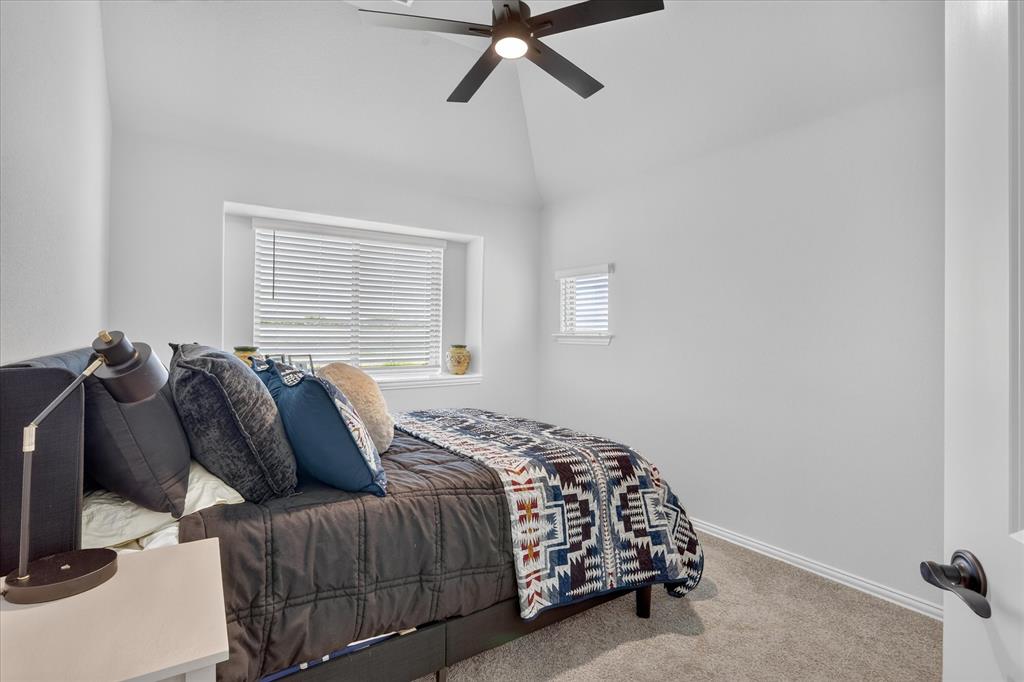833 Godley Ranch Godley, TX 76044 - Photo 23 of 31 Carpeted room featuring a ceiling fan, vaulted ceiling, and two windows with blinds