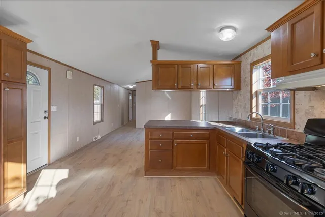 a kitchen with wooden cabinets and a stove top oven