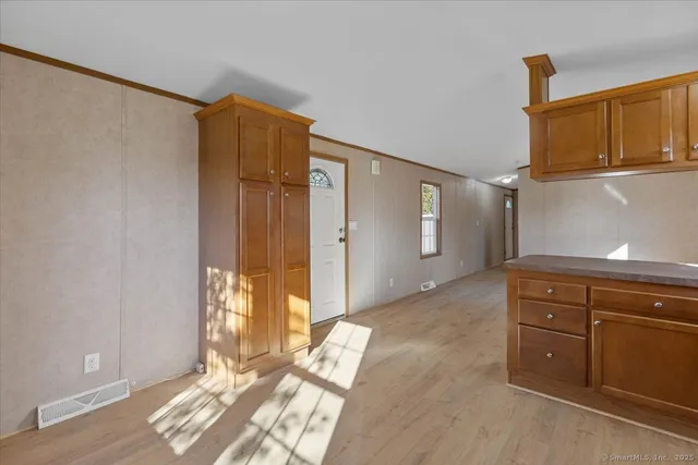 a view of a bedroom with wooden floor and windows