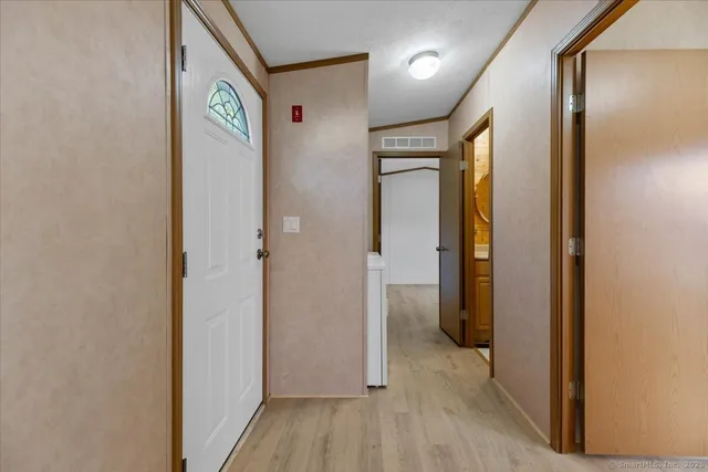 a view of a hallway with wooden shelves