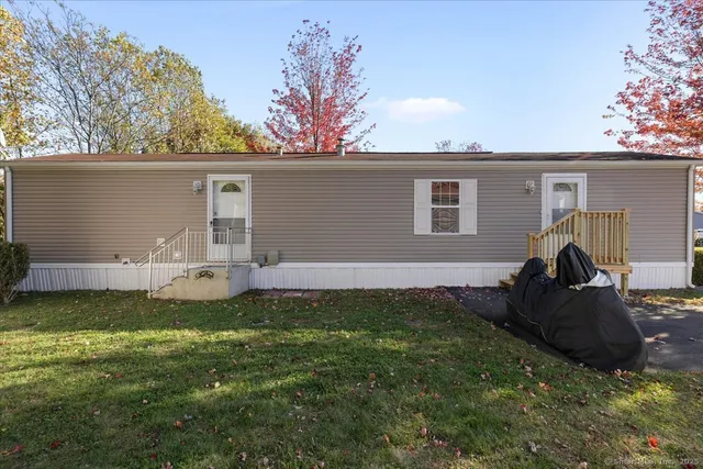 a backyard of a house with table and chairs