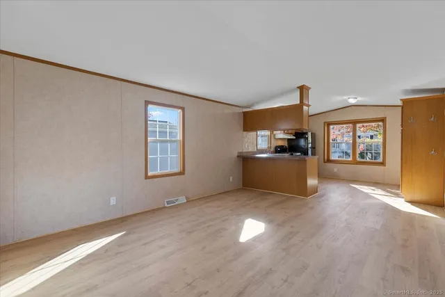 a view of a livingroom with wooden floor and windows