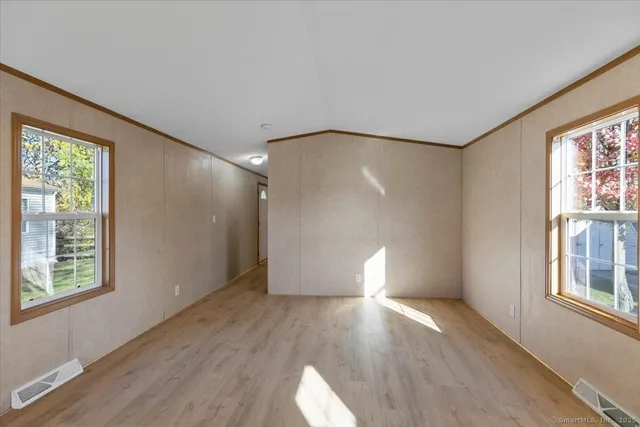 wooden floor in an empty room with a window