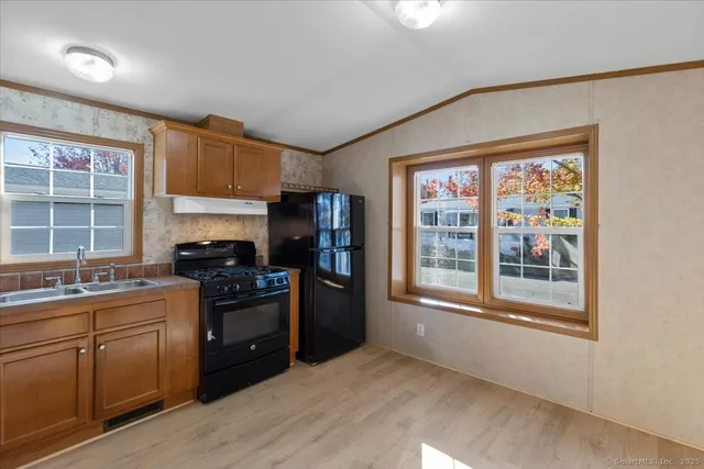 a kitchen with stainless steel appliances granite countertop a stove and a refrigerator