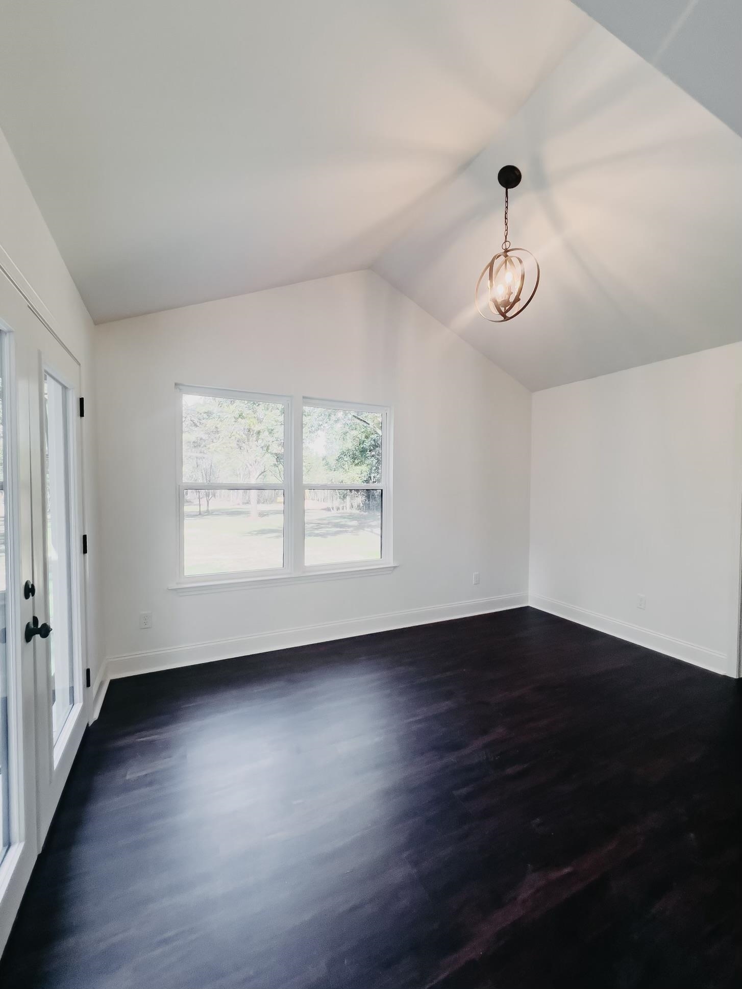 8515 Epperson Mill Road Millington, TN 38053 - Photo 12 of 32 Unfurnished room featuring vaulted ceiling and dark hardwood / wood-style flooring