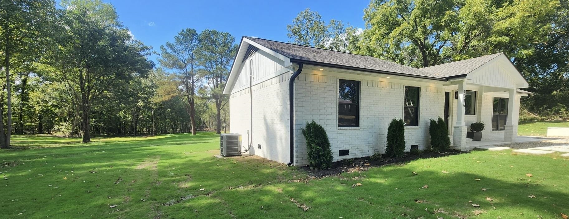 8515 Epperson Mill Road Millington, TN 38053 - Photo 2 of 32 View of home's exterior with a lawn and cooling unit