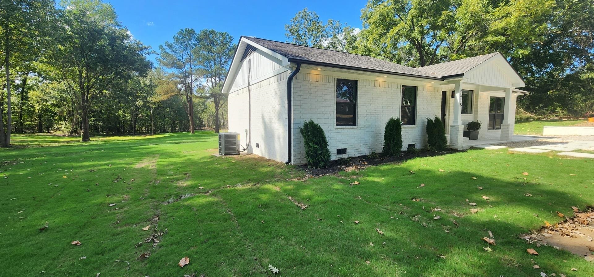 8515 Epperson Mill Road Millington, TN 38053 - Photo 30 of 32 View of side of property featuring central AC unit and a lawn
