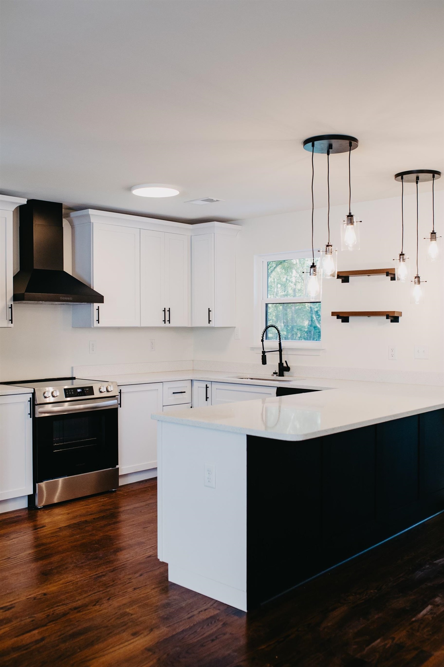 8515 Epperson Mill Road Millington, TN 38053 - Photo 6 of 32 Kitchen with stainless steel range with electric cooktop, white cabinets, hanging light fixtures, wall chimney exhaust hood, and dark hardwood / wood-style flooring