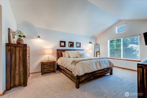 a spacious bedroom with a bed and large window